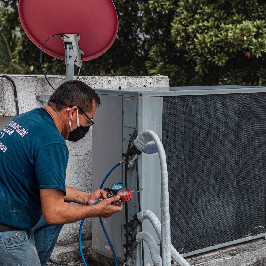 Technician performing a seasonal HVAC tune-up